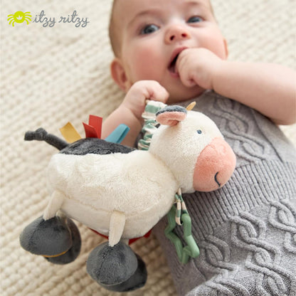 Itzy Ritzy Link & Love Toy for Stroller or Car Seat – Features Textured Ribbons, Crinkle Sounds, Clinking Rings & Silicone Teether – Designed for Ages 0 Months and Up (Cow)