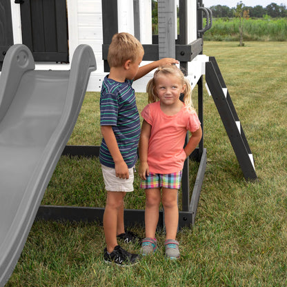 Backyard Discovery Sweetwater Heights White Elevated Cedar Wooden Kids Playhouse with Wave Slide, Play Kitchen, Step Ladder, Half Door, Wrap-Around Deck, Windows, Bell, Growth Chart for Outdoor Play